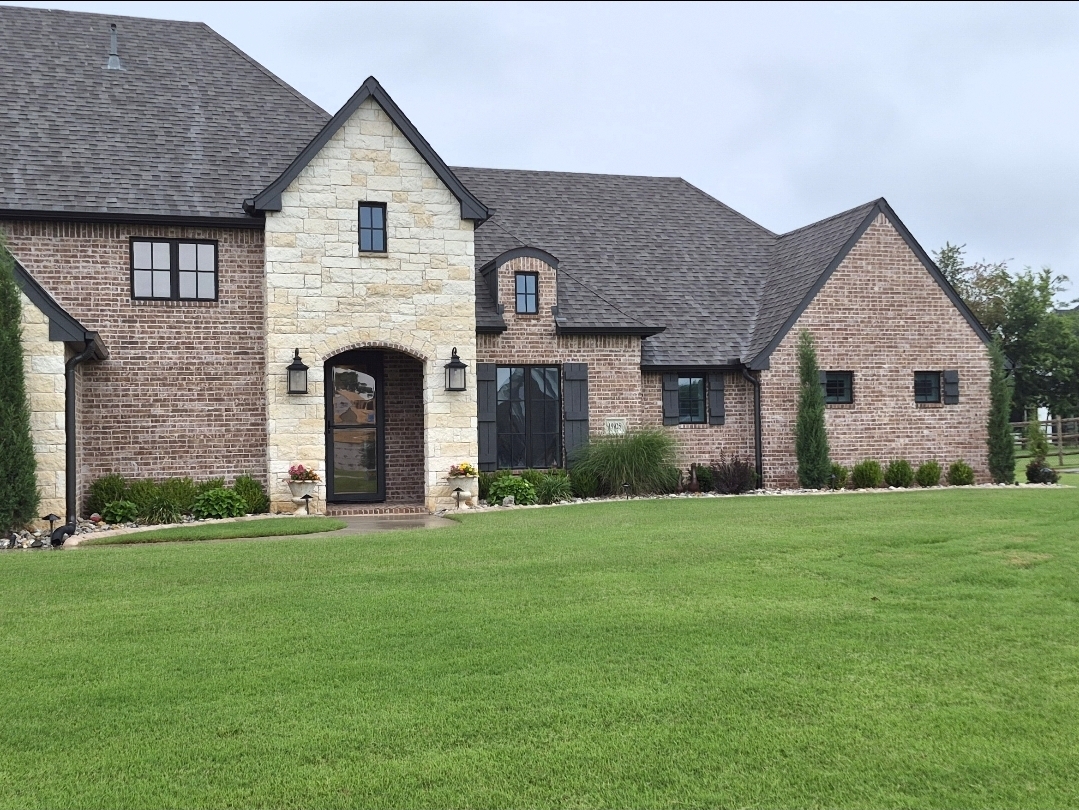 Brick estate home with tinted front entry windows