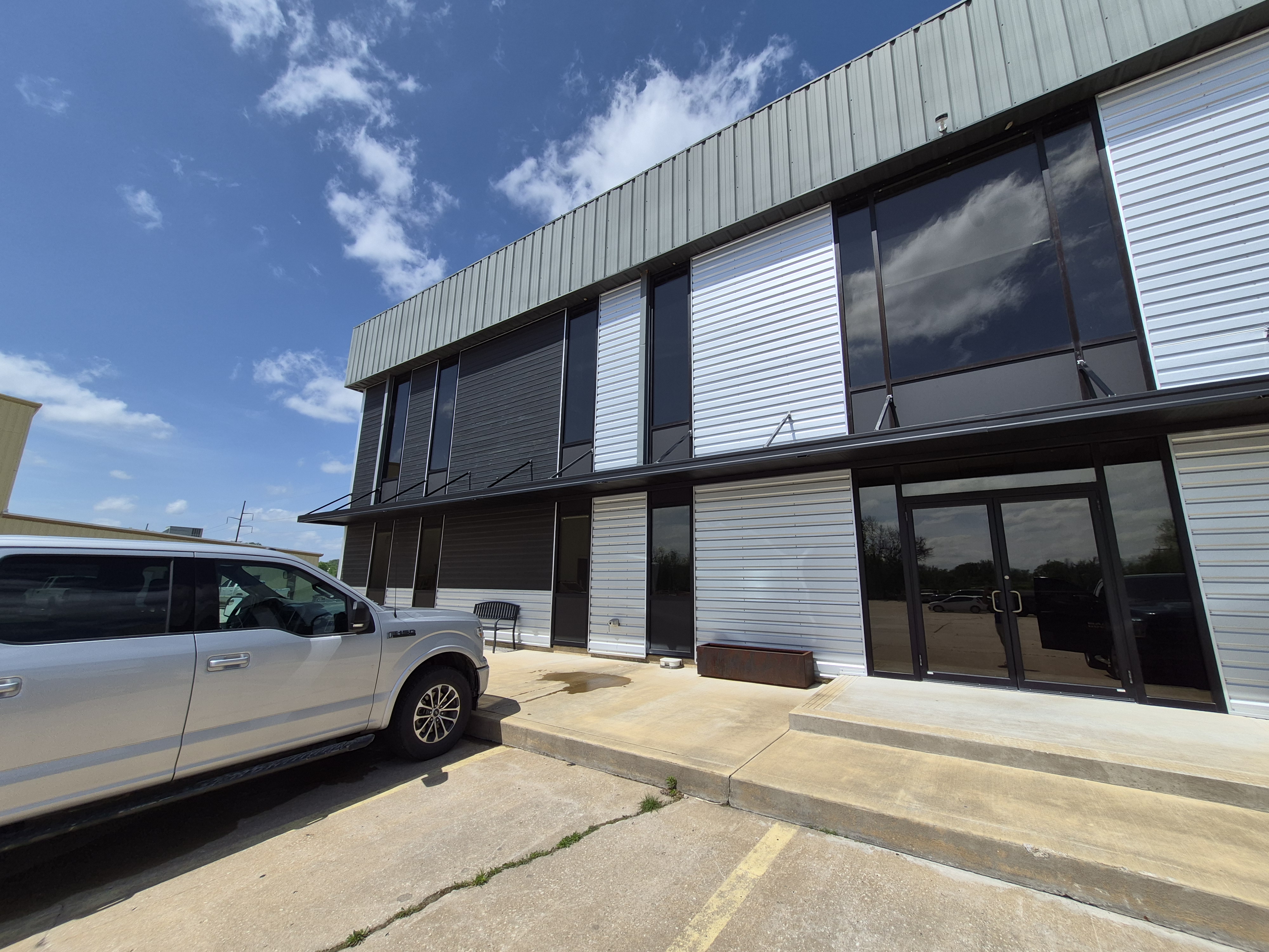 Tinted commercial office building with dark storefront glass